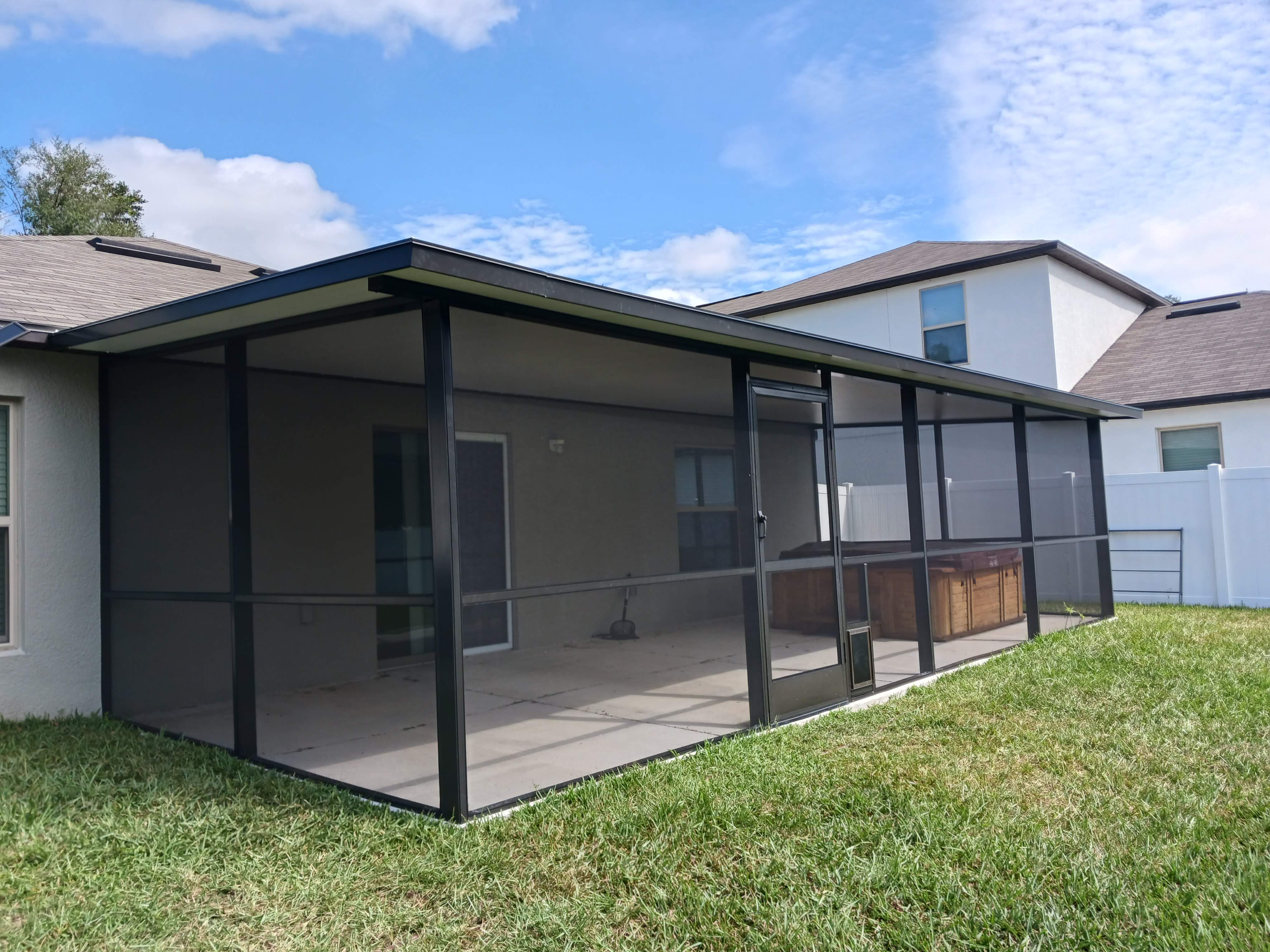 Completed screen lanai with dark aluminum frame — Tampa Bay