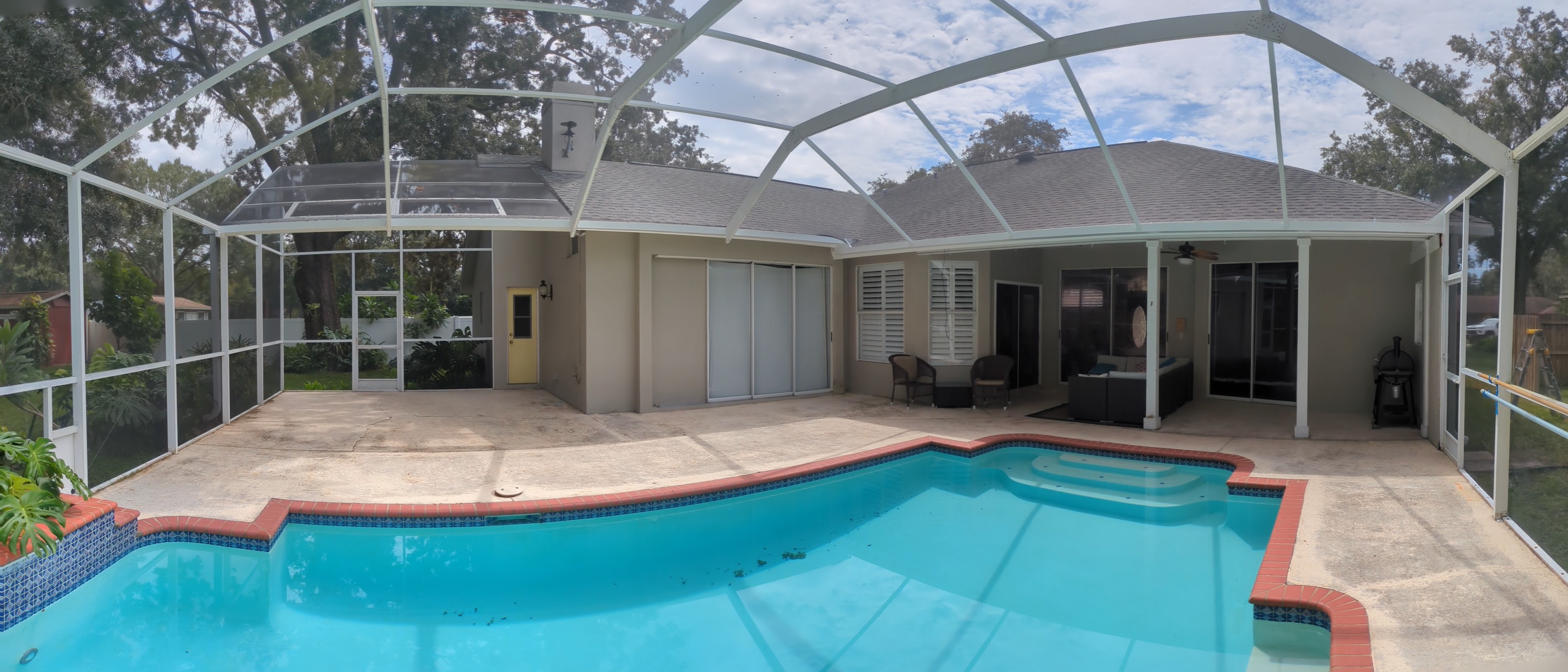 Panoramic view of completed screen enclosure across rear of home — Tampa Bay 2024